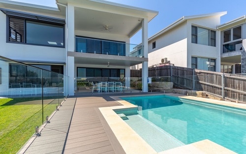 A modern home with a pool with the Glass Range pool interior